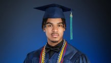 A senior class photo of Dennis Maliq Barnes. He wears a navy graduation robe against a deep blue background, wearing a turquoise tassel with a gold 23 charm signifying his graduating class.