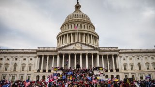 A large group of pro-Trump protesters stand on the East steps of the Capitol Building after storming its grounds on January 6, 2021 in Washington, DC.