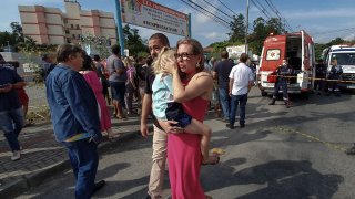 FILE: A toy car is placed on the coffin of Juan Miguel Soares Silva, 4, one of the victims of a 2017 Brazilian nursery school attack.