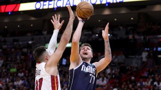 Luka Doncic #77 of the Dallas Mavericks shoots the ball over Max Strus #31 of the Miami Heat during the second quarter of the game at Miami-Dade Arena on April 01, 2023 in Miami, Florida.