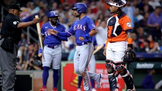 Apr 14, 2023; Houston, Texas, USA; Texas Rangers second baseman Marcus Semien (2) crosses home plate to score a run against the Houston Astros during the first inning at Minute Maid Park. Mandatory Credit: Erik Williams-USA TODAY Sports