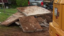 Police use excavating equipment to look under an Everman porch for a boy missing since October 2022. Photo taken April 11, 2023.