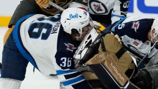 Winnipeg Jets center Morgan Barron (36) gets his face cut on the skate of Vegas Golden Knights goaltender Laurent Brossoit (39) during the first period of Game 1 of an NHL hockey Stanley Cup first-round playoff series Tuesday, April 18, 2023, in Las Vegas.