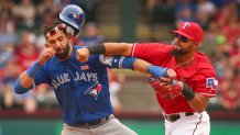 Toronto Blue Jays Jose Bautista (19) gets hit by Texas Rangers second baseman Rougned Odor (12) after Bautista slid into second in the 8th inning at Globe Life Park on May 15, 2016 in Arlington, Texas. The Rangers won 7-6. (Richard W. Rodriguez/Fort Worth Star-Telegram/Tribune News Service via Getty Images)