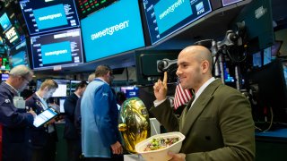 Nicolas Jammet, chief concept officer and co-founder of Sweetgreen Inc., right, eats a salad during the company’s initial public offering (IPO) on the floor of the New York Stock Exchange (NYSE) in New York, U.S., on Thursday, Nov. 18, 2021.