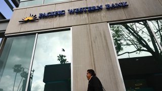 A pedestrian walks past a Pacific Western Bank branch in Beverly Hills, California on May 4, 2023.