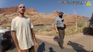 FILE- In this image taken from police body camera video provided by The Moab Police Department, Brian Laundrie talks to a police officer after police pulled over the van he was traveling in with his girlfriend, Gabrielle “Gabby” Petito, near the entrance to Arches National Park in Utah on Aug. 12, 2021.