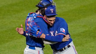 Texas Rangers starting pitcher Nathan Eovaldi, right, celebrates the team's 6-1 win over the Pittsburgh Pirates in a baseball game with catcher Jonah Heim in Pittsburgh on Tuesday, May 23, 2023.