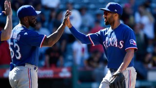 ANAHEIM, CA – MAY 07: Adolis Garcia #53 of the Texas Rangers high fives Marcus Semien #2 after defeating the Los Angeles Angels, 16-8, at Angel Stadium of Anaheim on May 7, 2023 in Anaheim, California.