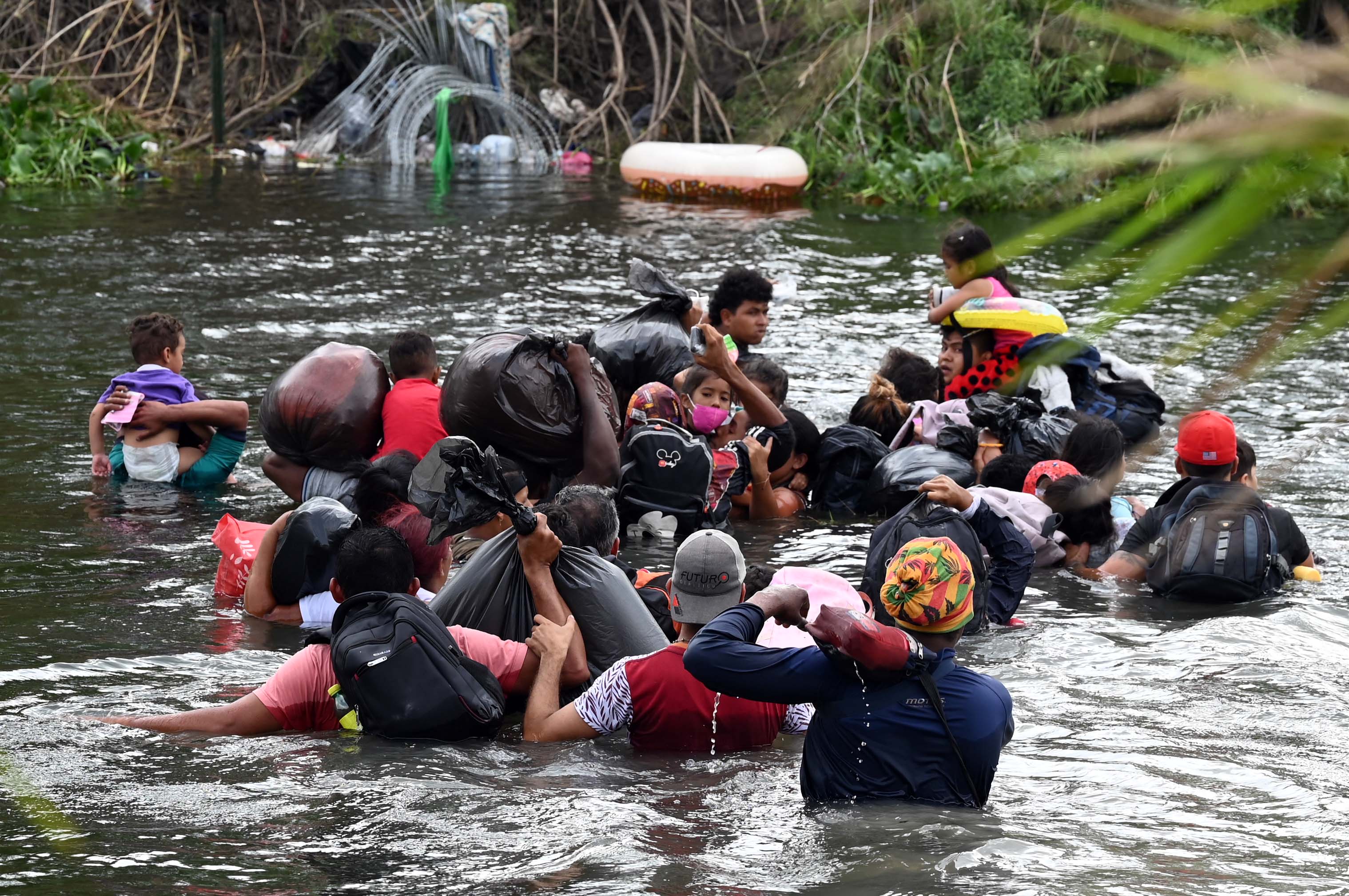 Migrants travel through the waters of the Rio Grande to the U.S., as seen from Matamoros, Mexico, May 11, 2023.