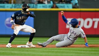 SEATTLE, WASHINGTON – MAY 08: Marcus Semien #2 of the Texas Rangers steals second base during the eighth inning against the Seattle Mariners at T-Mobile Park on May 08, 2023 in Seattle, Washington. The Texas Rangers won 2-1. (Photo by Alika Jenner/Getty Images)