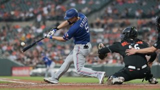 May 26, 2023; Baltimore, Maryland, USA; Texas Rangers shortstop Corey Seager (5) hits a fourth inning grand slam off Baltimore Orioles starting pitcher Grayson Rodriguez (30) at Oriole Park at Camden Yards.