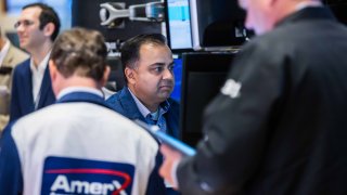 Traders work on the floor of the New York Stock Exchange. 