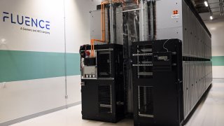 Rows of cabinets containing lithium ion batteries supplied by Fluence, a Siemens and AES Company, are seen inside the AES Alamitos Battery Energy Storage System, which provides stored renewable energy to supply electricity during peak demand periods, in Long Beach, California on September 16, 2022. 