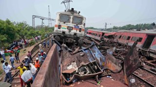 Rescuers work at the site of passenger trains that derailed