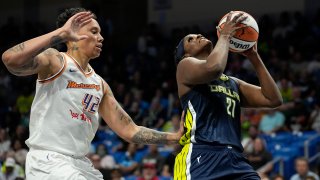 Dallas Wings center Kalani Brown (21) shoots next to Phoenix Mercury center Brittney Griner during the first half of a WNBA basketball game Wednesday, June 7, 2023, in Arlington, Texas.