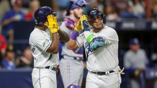 Tampa Bay Rays' Isaac Paredes, right, celebrates after his three-run home run with Randy Arozarena, left, in front of Texas Rangers catcher Jonah Heim, center, during the third inning of a baseball game Friday, June 9, 2023, in St. Petersburg, Fla.