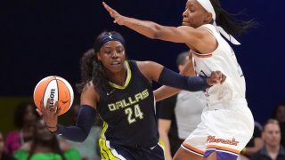 Dallas Wings guard Arike Ogunbowale (24) keeps the ball from Phoenix Mercury guard Shey Peddy, right, during the second half of a WNBA basketball basketball game in Arlington, Texas, Friday, June 9, 2023.