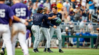 Oral Roberts pitcher Cade Denton, right, is congratulated by Harley Gollert (11) and Drew Stahl, second from right, after their victory over TCU in a baseball game at the NCAA College World Series in Omaha, Neb., Friday, June 16, 2023.