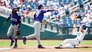 TCU infielder Anthony Silva (5) turns a double play in the second inning against Oral Roberts infielder Jake McMurray (4) in a baseball game at the NCAA College World Series in Omaha, Neb., Tuesday, June 20, 2023.