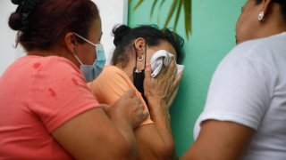 Relatives of inmates wait in distress outside the entrance to the women’s prison in Tamara, on the outskirts of Tegucigalpa, Honduras, June 20, 2023.