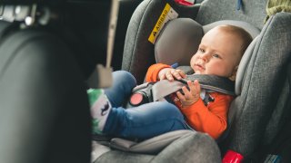 Baby sit in the car seat for safety.