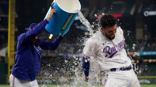 Marcus Semien #2 of the Texas Rangers is doused with water by Martin Perez #54 after the game against the Los Angeles Angels at Globe Life Field on June 14, 2023 in Arlington, Texas.