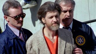 In this April 4, 1996 file photo, Ted Kaczynski, better known as the Unabomber, is flanked by federal agents as he is led to a car from the federal courthouse in Helena, Mont. Kaczynski, known as the “Unabomber,” has died in federal prison, a spokesperson for the Bureau of Prisons told The Associated Press on Saturday, June 10, 2023.