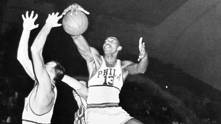 Wilt Chamberlain of the Philadelphia Warriors grabs the ball during a game against the New York Knicks in 1959.