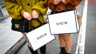 Customers hold shopping bags outside the Shein Tokyo showroom in Tokyo, Nov. 13, 2022.