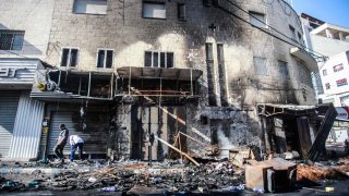 Palestinians inspect shops burnt and destroyed by Israeli forces in the middle of the Jenin refugee camp, during the storming of the camp near the city of Jenin, in the northern occupied West Bank.