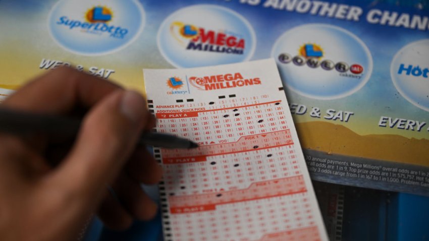 A person plays Mega millions lottery at a gas station in Trona, California, United States on July 11, 2023.