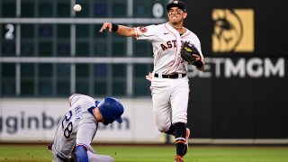 HOUSTON, TEXAS – JULY 25: Mauricio Dubon #14 of the Houston Astros fields a ball in the seventh inning against the Texas Rangers at Minute Maid Park on July 25, 2023 in Houston, Texas.