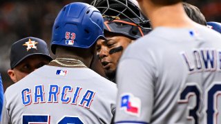 HOUSTON, TEXAS – JULY 26: Adolis Garcia #53 of the Texas Rangers exchanges words with catcher Martin Maldonado #15 of the Houston Astros after Garcia’s grand slam in the fifth inning at Minute Maid Park on July 26, 2023 in Houston, Texas.