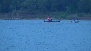 Divers with the Grapevine Fire Department, on July 14, 2023, search for a man presumed to have drowned the day before.