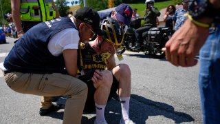 Doctors tend to Belgium’s Nathan van Hooydonck who crashed during the fifteenth stage of the Tour de France cycling race over 179 kilometers (111 miles) with start in Les Gets Les Portes du Soleil and finish in Saint-Gervais Mont-Blanc, France, Sunday, July 16, 2023.