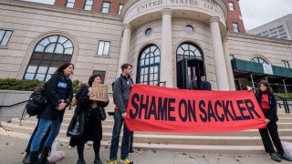 Protesters holding banners outside the courthouse. Members of P.A.I.N. (Prescription Addiction Intervention Now) and Truth Pharm staged a rally and die-in outside New York’s Southern District Federal Court in White Plains.