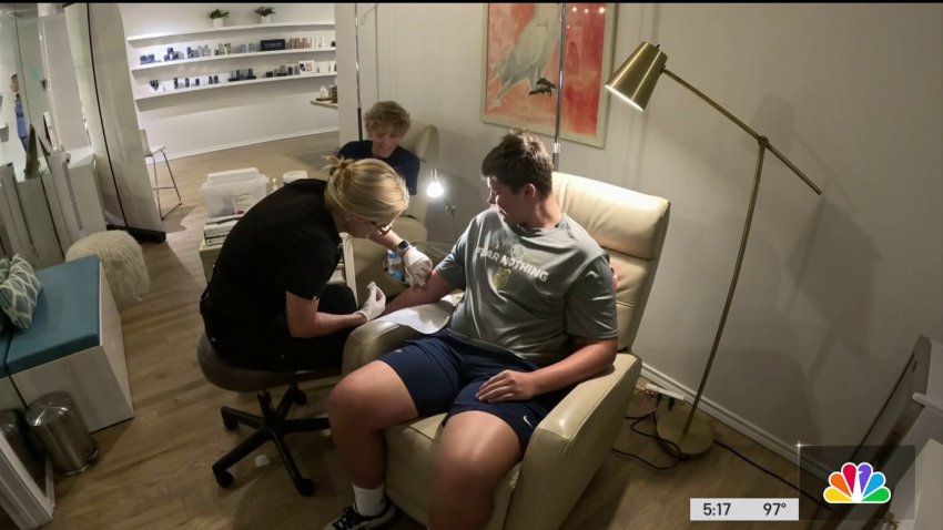 Some high school football players using IV fluids to hydrate