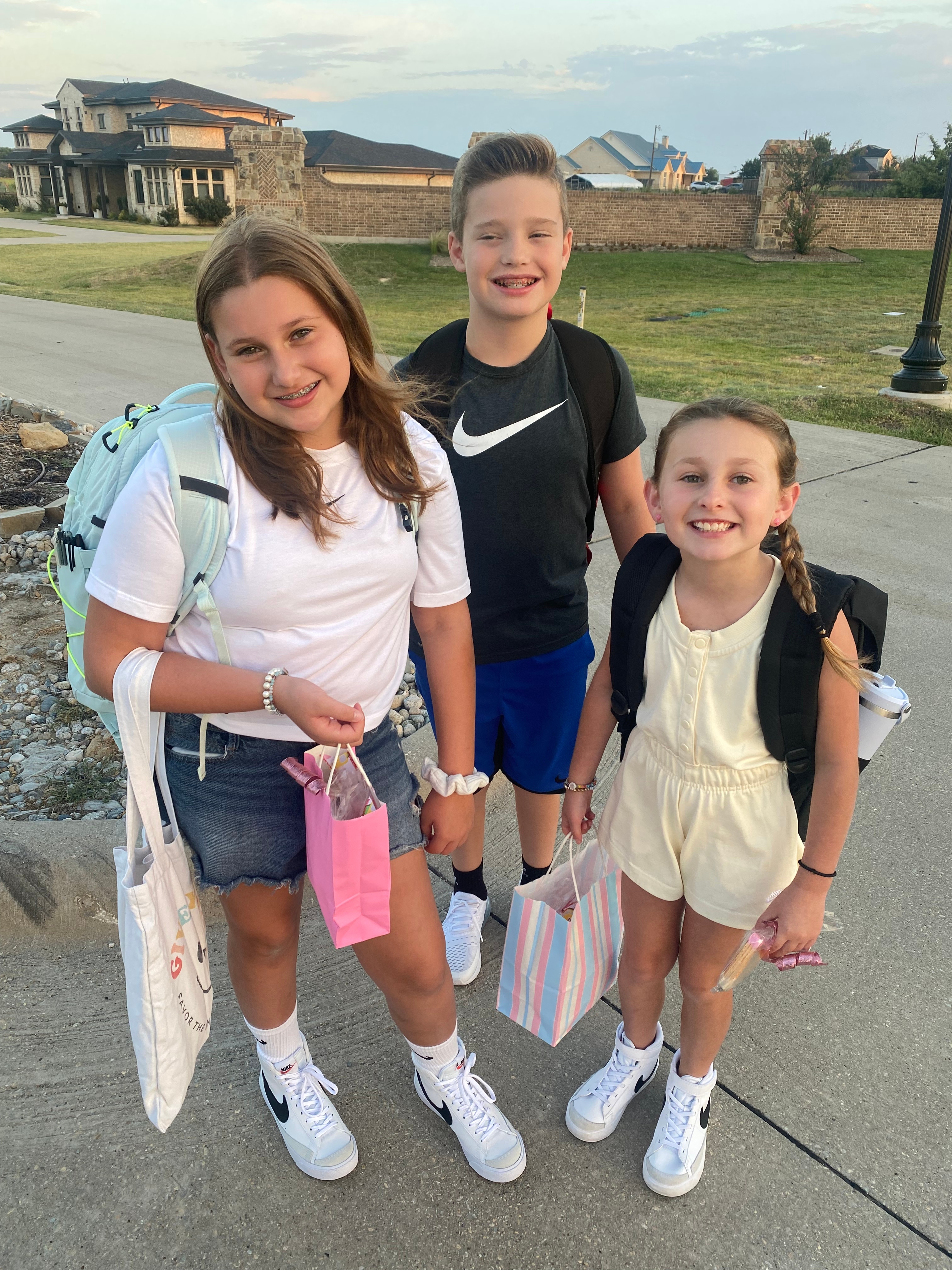 Ava and Etta Wilkerson and neighbor, Max Quiggley waiting for the school bus on their first day back to LoveJoy ISD