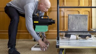 In this photo provided by the U.S. Military Academy at West Point, Kenneth Allen, professor of nuclear engineering, conducts an X-ray on a time capsule, Friday, June 9, 2023.