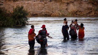 PIEDRAS NEGRAS, MEXICO – AUGUST 04: Migrants try to cross the border between Piedras Negras and Eagle Pass, in Piedras Negras, Mexico on August 04, 2023. The governor of Texas installed a barrier with floating buoys to prevent the crossing of migrants, near this facility the body of two Honduran migrants who drowned was found. They tragically lost their lives while attempting to cross the river.