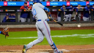 FLUSHING, NY – AUGUST 28: Texas Rangers First Baseman Nathaniel Lowe (30) hits an RBI single during the ninth inning of.a Major League Baseball game between the Texas Rangers and the New York Mets on August 28, 2023, at Citi Field in Flushing, NY.