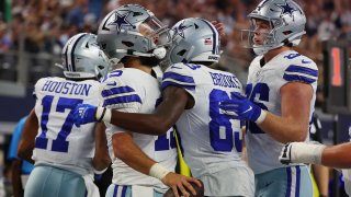 ARLINGTON, TEXAS – AUGUST 26: Will Grier #15 celebrates with Jalen Brooks #83 and Luke Schoonmaker #86 of the Dallas Cowboys after a first quarter touchdown against the Las Vegas Raiders in a preseason game at AT&T Stadium on August 26, 2023 in Arlington, Texas.