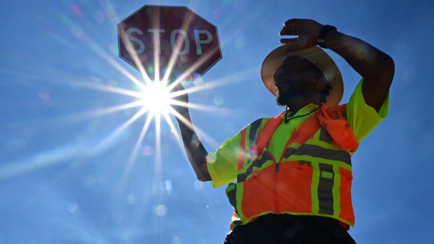 TOPSHOT – Traffic warden Rai Rogers mans his street corner during an 8-hour shift under the hot sun in Las Vegas, Nevada on July 12, 2023, where temperatures reached 106 degrees amid an ongoing heatwave. More than 50 million Americans are set to bake under dangerously high temperatures this week, from California to Texas to Florida, as a heat wave builds across the southern United States. (Photo by Frederic J. BROWN / AFP) (Photo by FREDERIC J. BROWN/AFP via Getty Images)