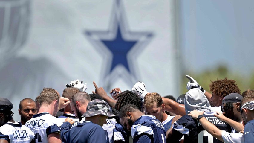 Dallas Cowboy players huddle during training camp at River Ridge Playing Fields on July 27, 2023 in Oxnard, California.