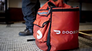 A DoorDash Inc. delivery bag sits on the floor at Chef Geoff’s restaurant in Washington, D.C.