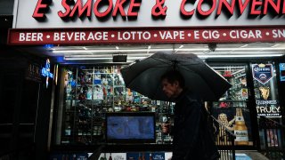 A pedestrian passes a smoke shop in New York City on June 16, 2023. New York authorities are cracking down on unlicensed smoke shops that are selling cannabis.