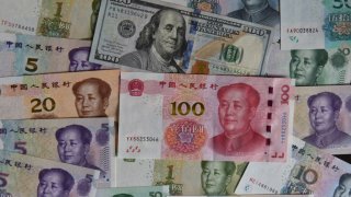 Photo taken on Aug 17, 2023 shows US dollars and Chinese yuan in Fuyang city, East China’s Anhui province.