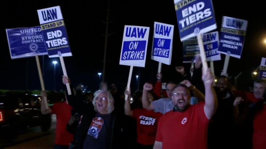 UAW workers with signs on strike