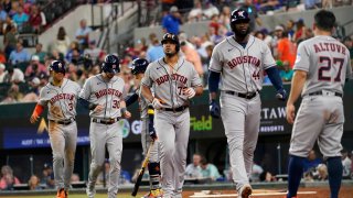 Houston Astros’ Jose Altuve (27) waits to congratulate Jose Abreu (79) after Abreau hit a grand slam that also scored Jeremy Pena (3), Kyle Tucker (30) and Yordan Alvarez (44) in the third inning of a baseball game, Wednesday, Sept. 6, 2023, in Arlington, Texas.